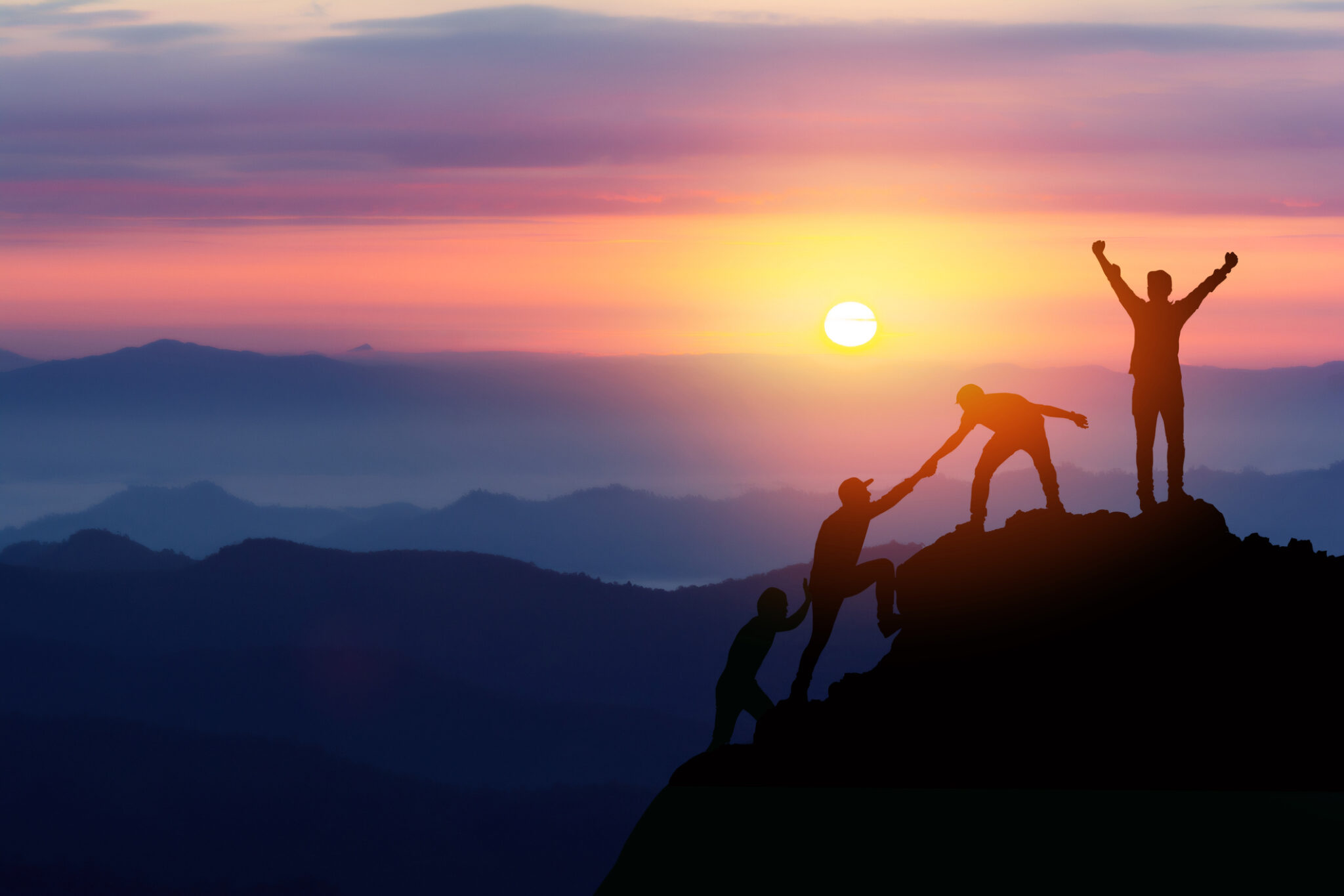 Teamwork friendship hiking help each other trust assistance silhouette in mountains, sunrise. Teamwork of two men hiker helping each other on top of mountain climbing team beautiful sunrise landscape